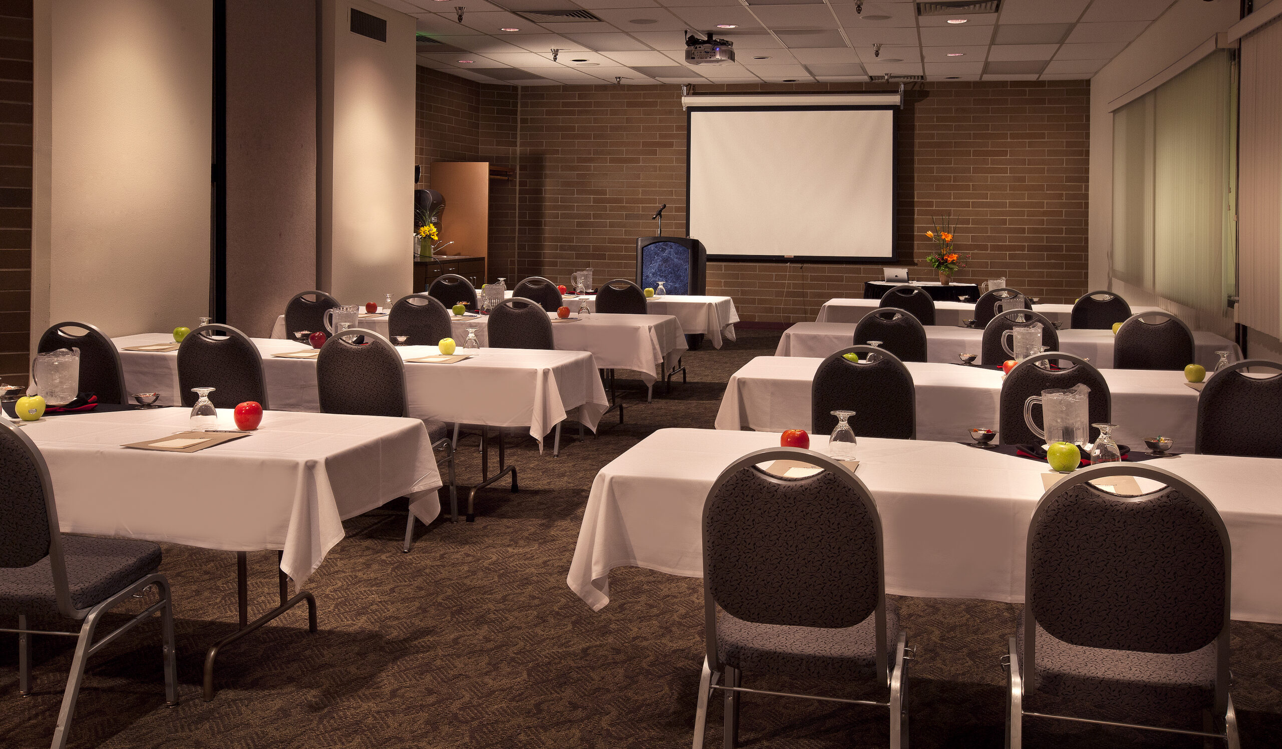 Empty conference room with tables and chairs.