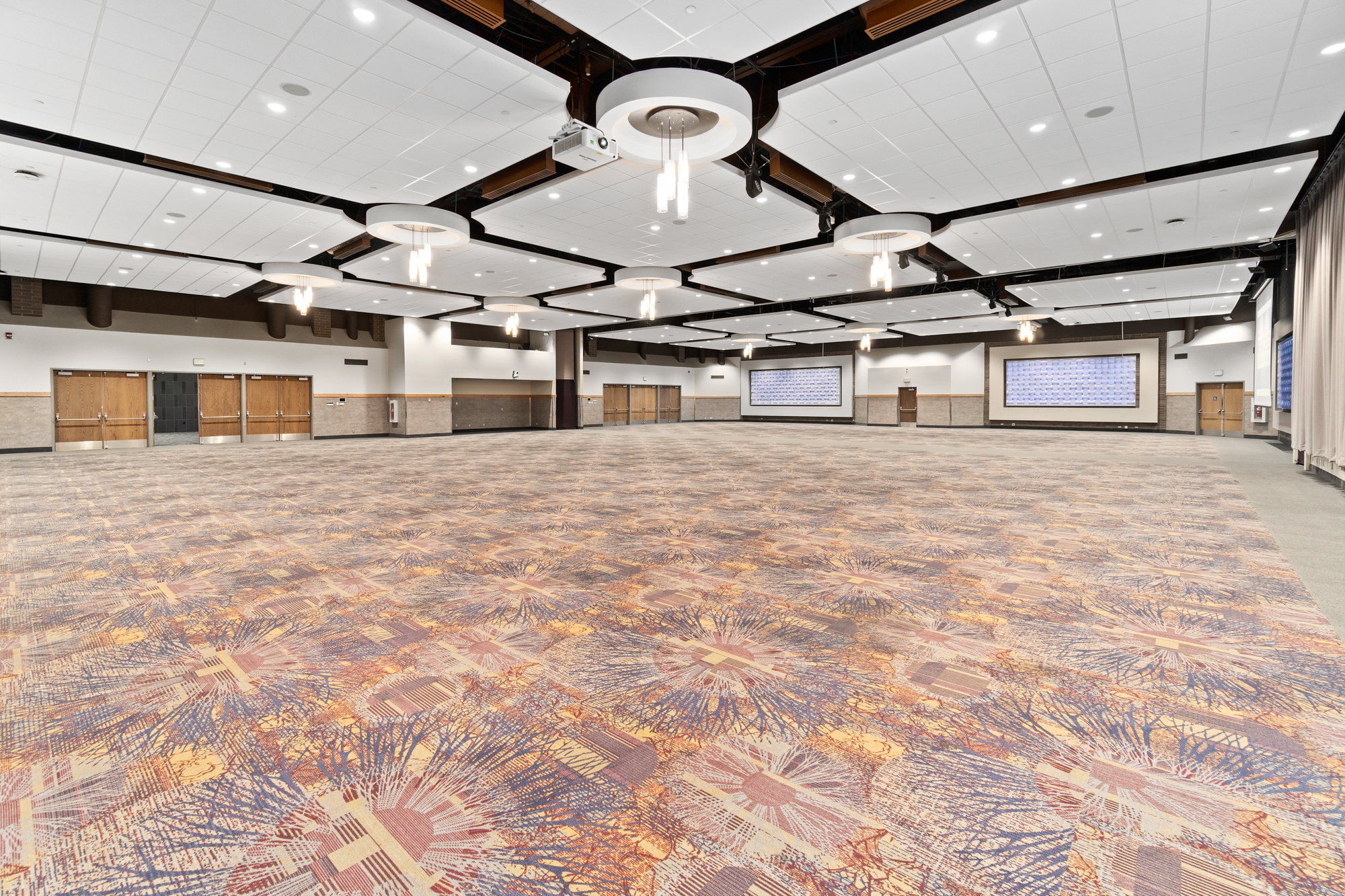Spacious conference room with decorative ceiling lights.