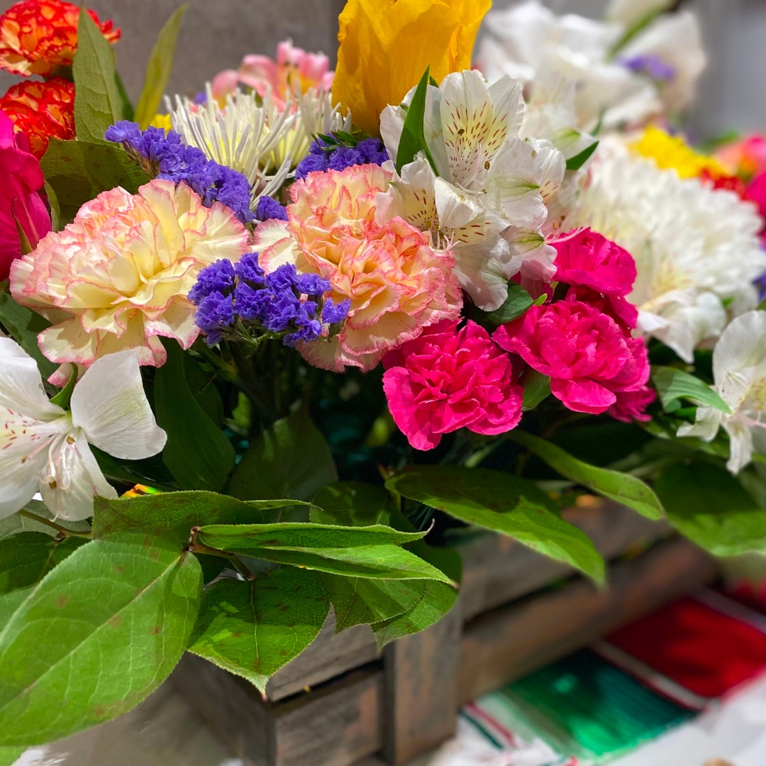 Vibrant bouquet of assorted colorful flowers in vase.