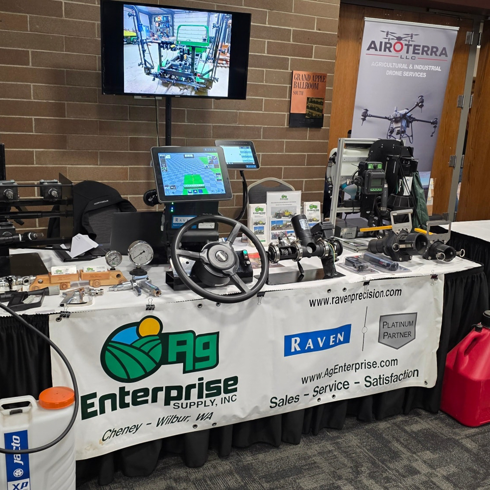Agricultural supply booth featuring technology and equipment display.