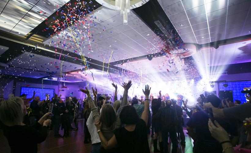 Celebratory event with people and confetti indoors.