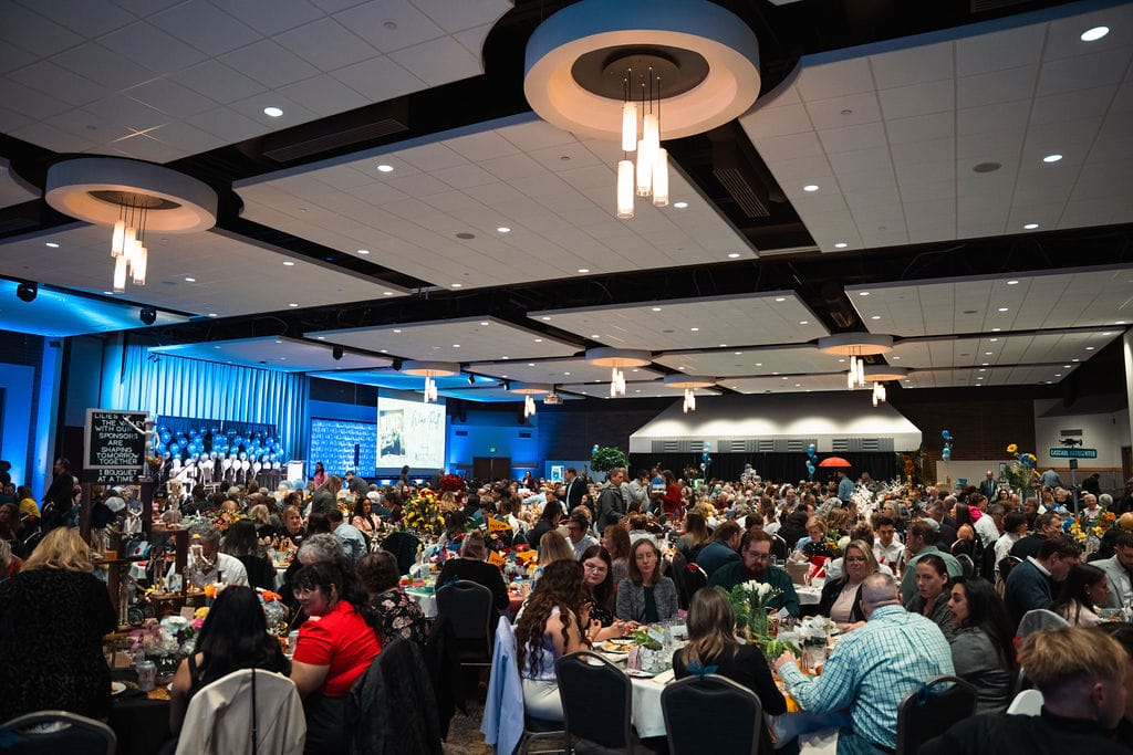 Large event with seated attendees and stage.