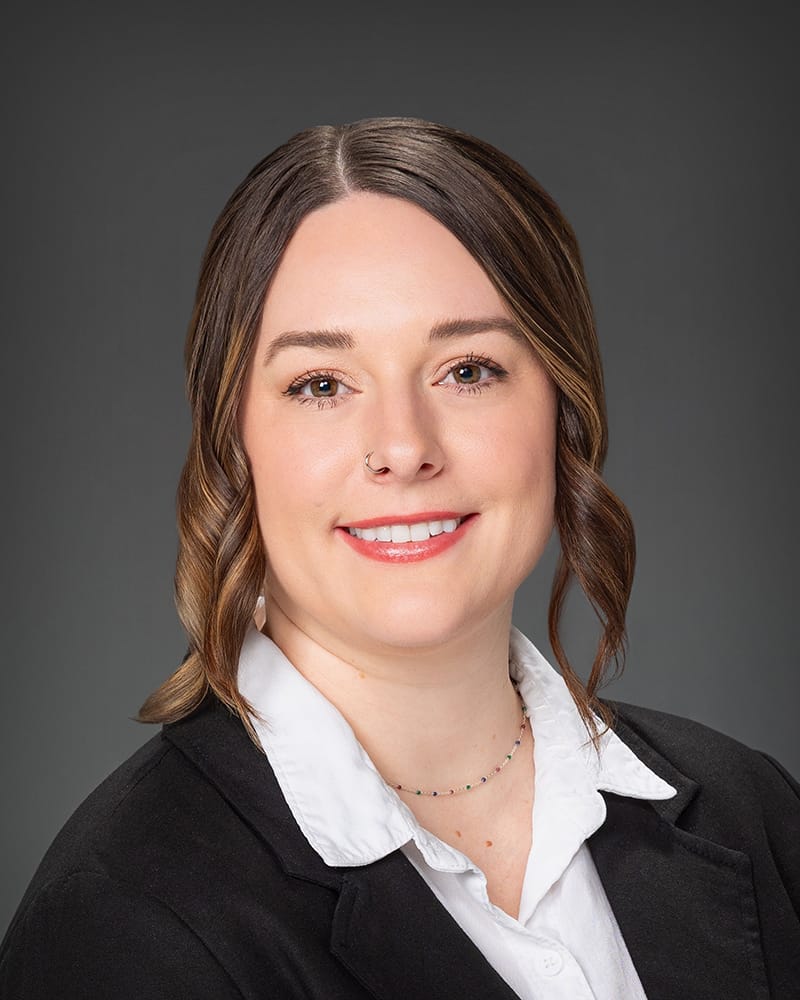 Smiling businesswoman in a professional suit portrait.
