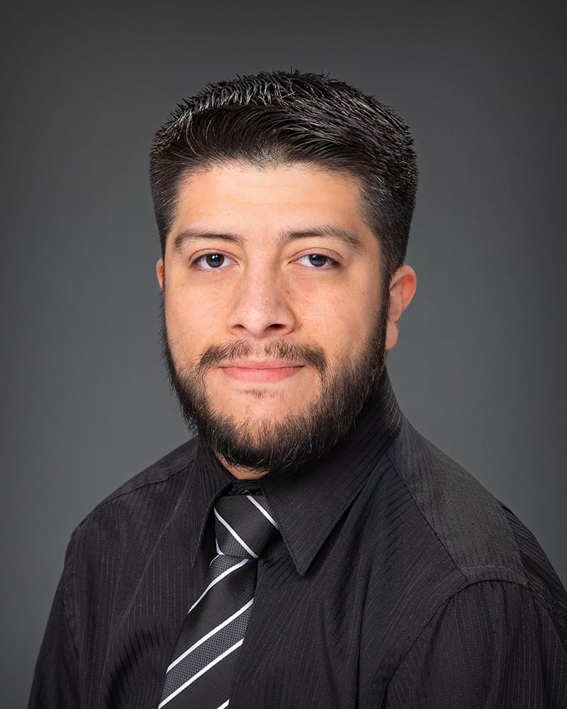 Man in black shirt with patterned tie