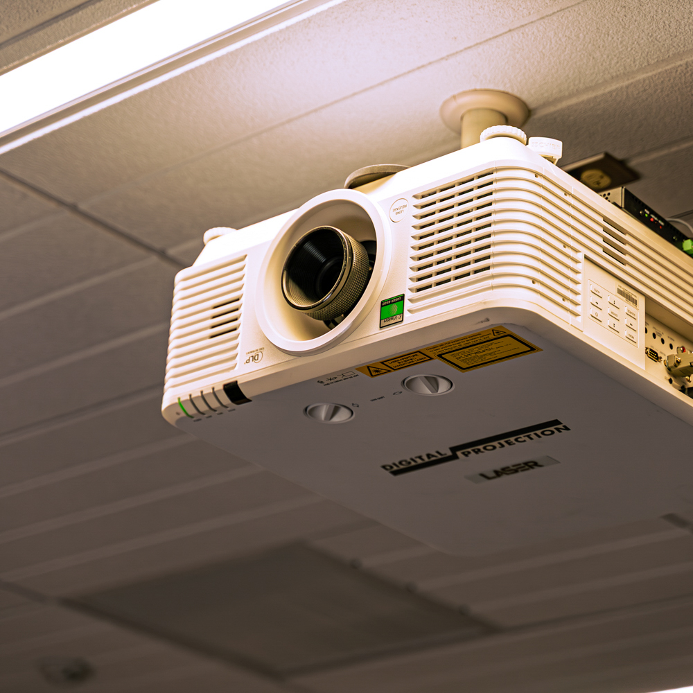 Ceiling-mounted digital projector in a room