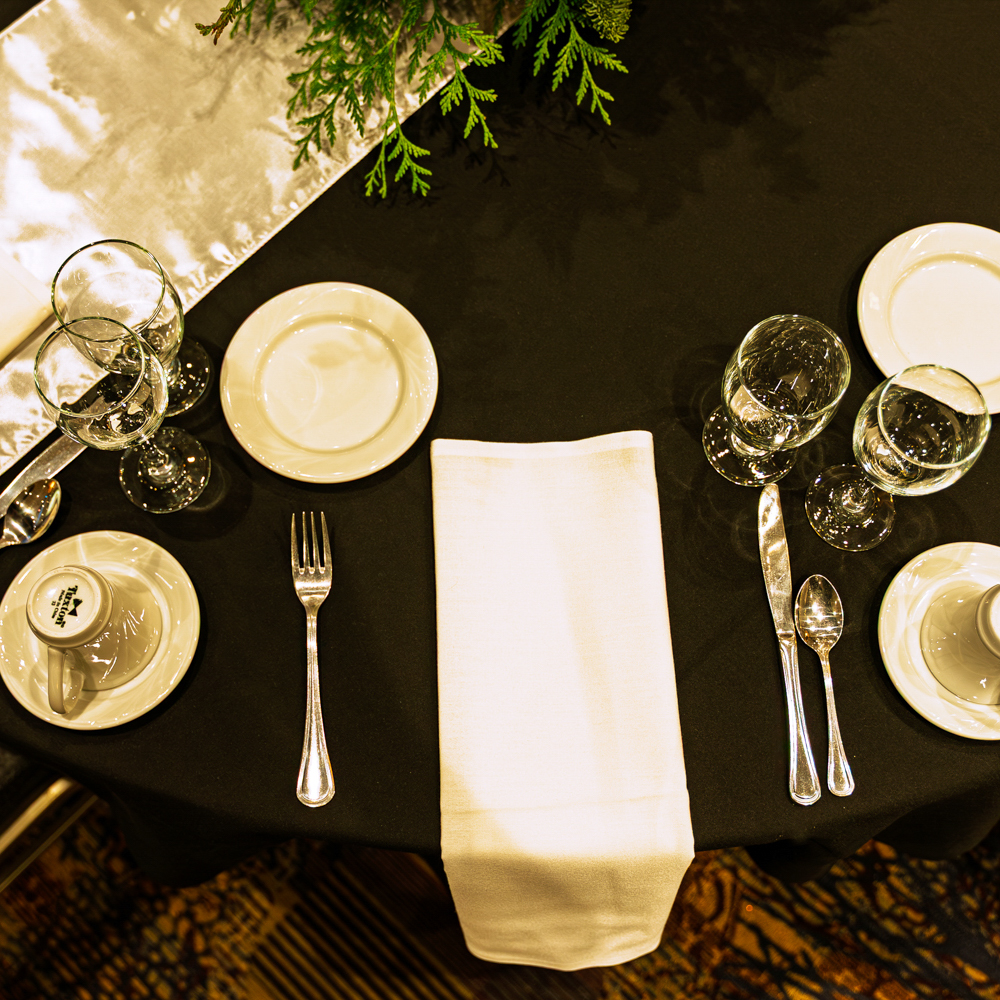 Elegant dinner table setting with silverware and napkins