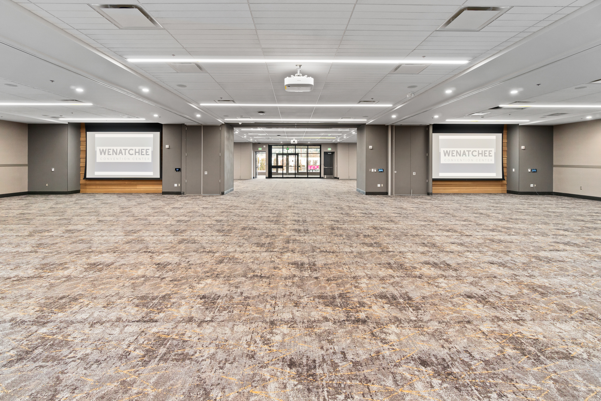 Spacious convention center interior with projectors.