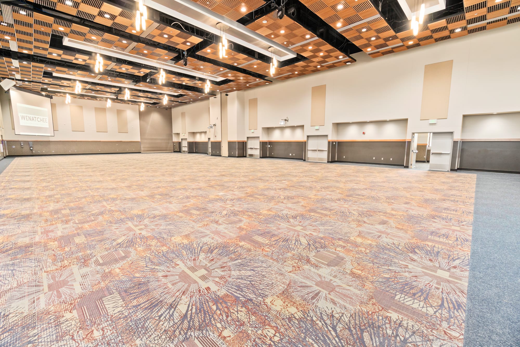 Large empty conference room with patterned carpet.
