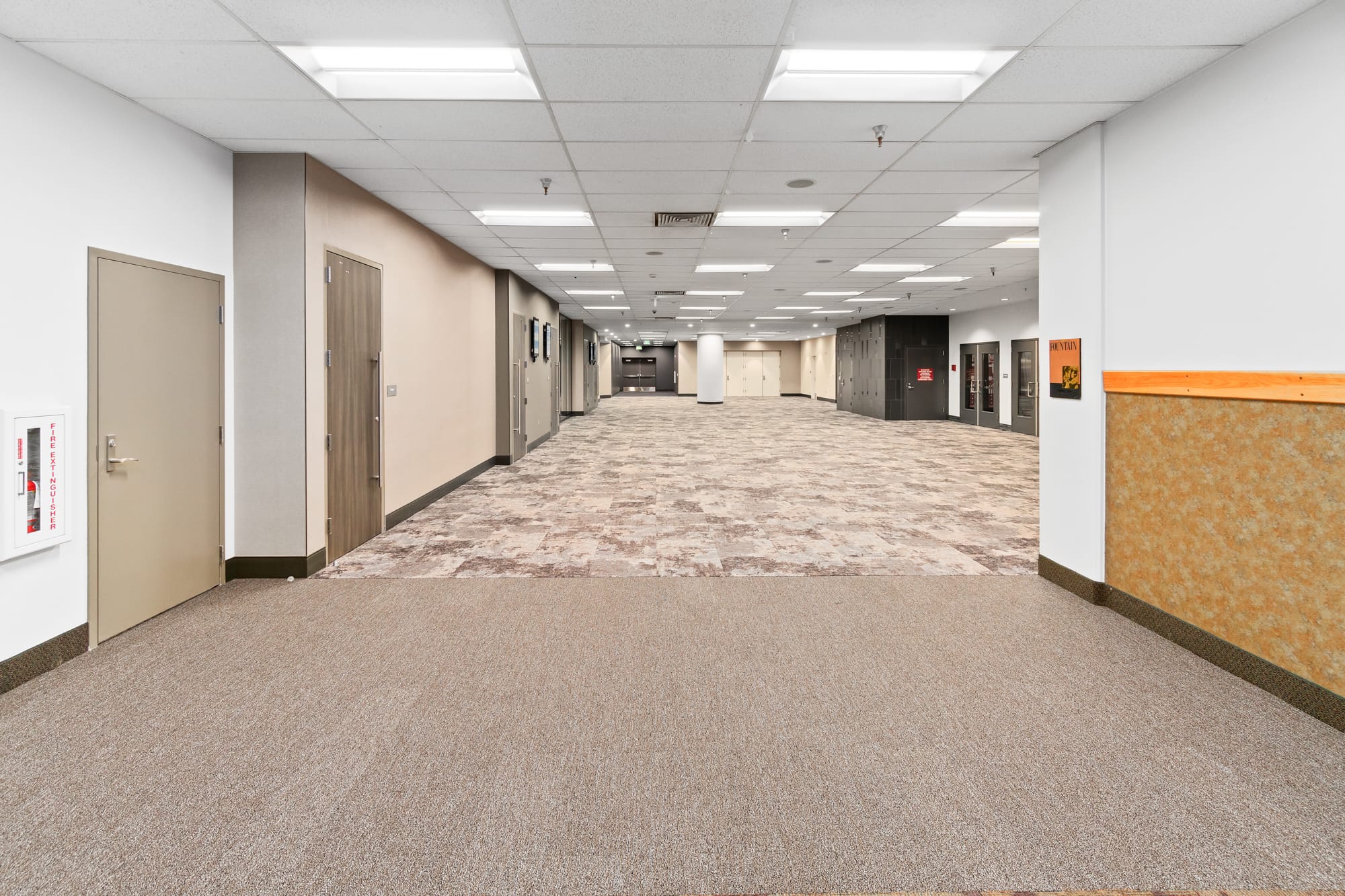 Empty office corridor with beige carpeting