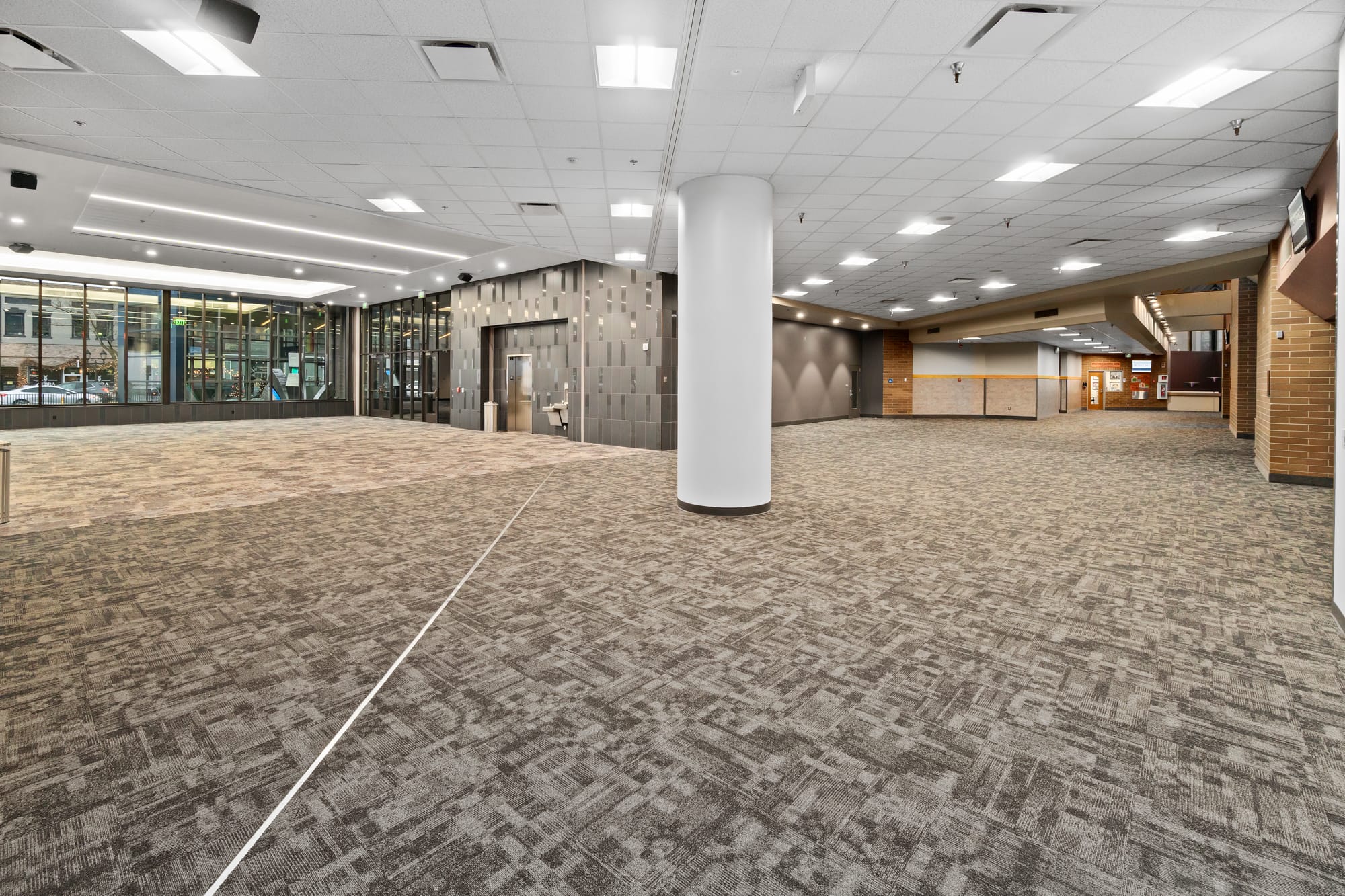 Spacious lobby with modern design and carpeting.
