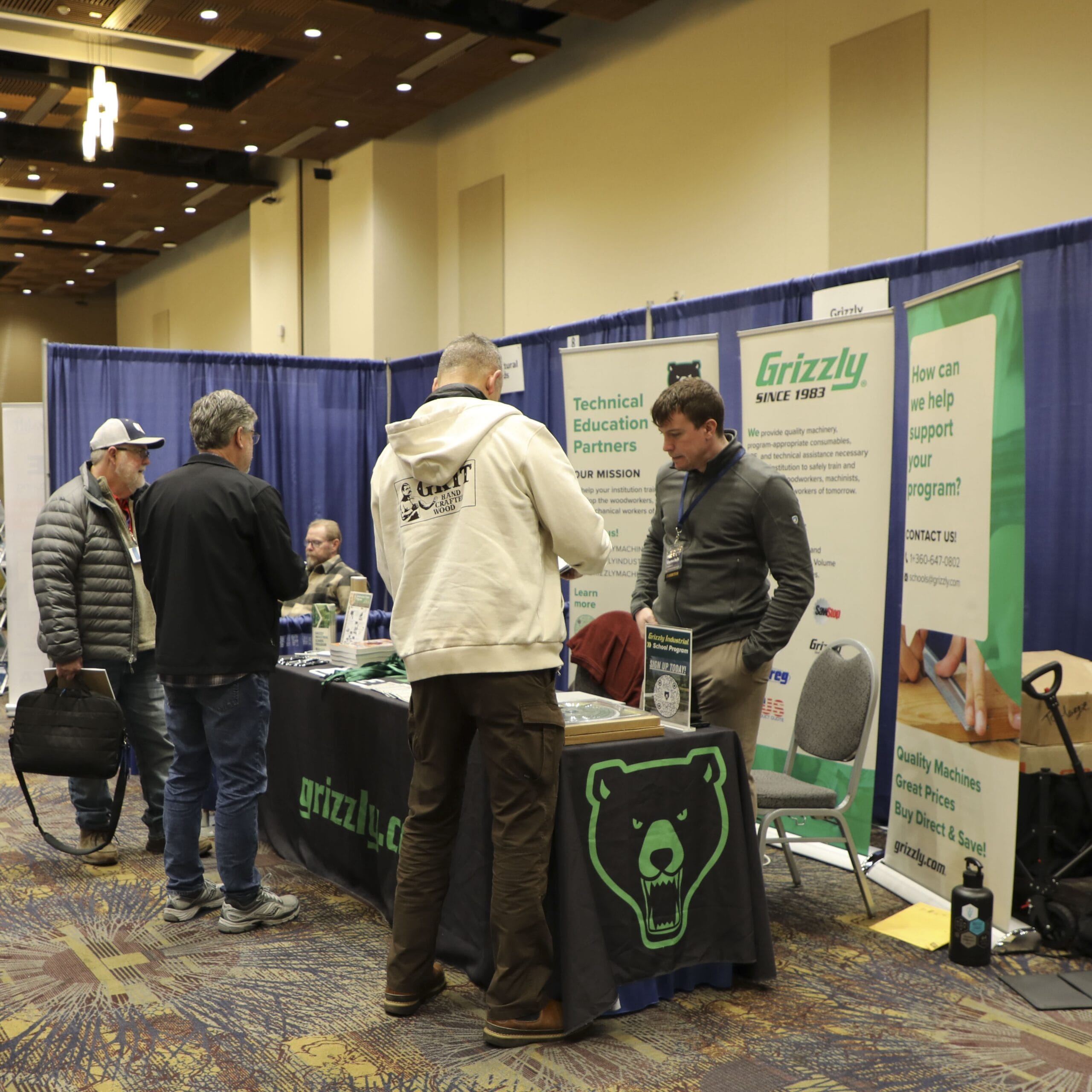 People at technical education expo booth.