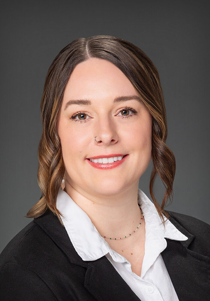 Smiling businesswoman in a professional suit portrait.