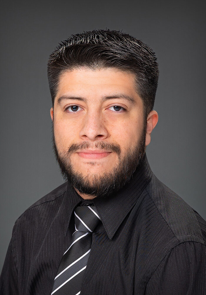 Man in black shirt with patterned tie